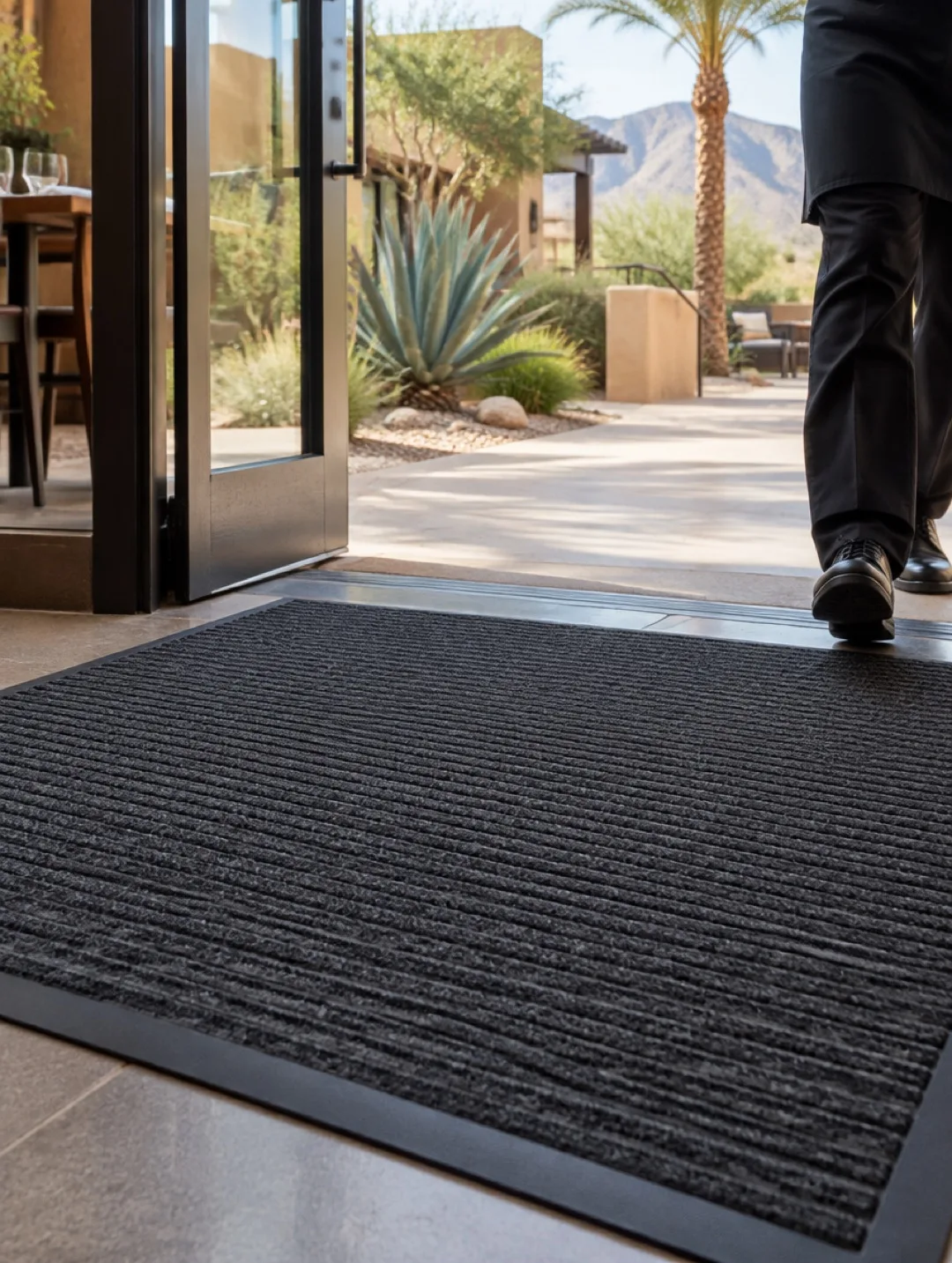Charcoal entrance mat at a desert restaurant entrance